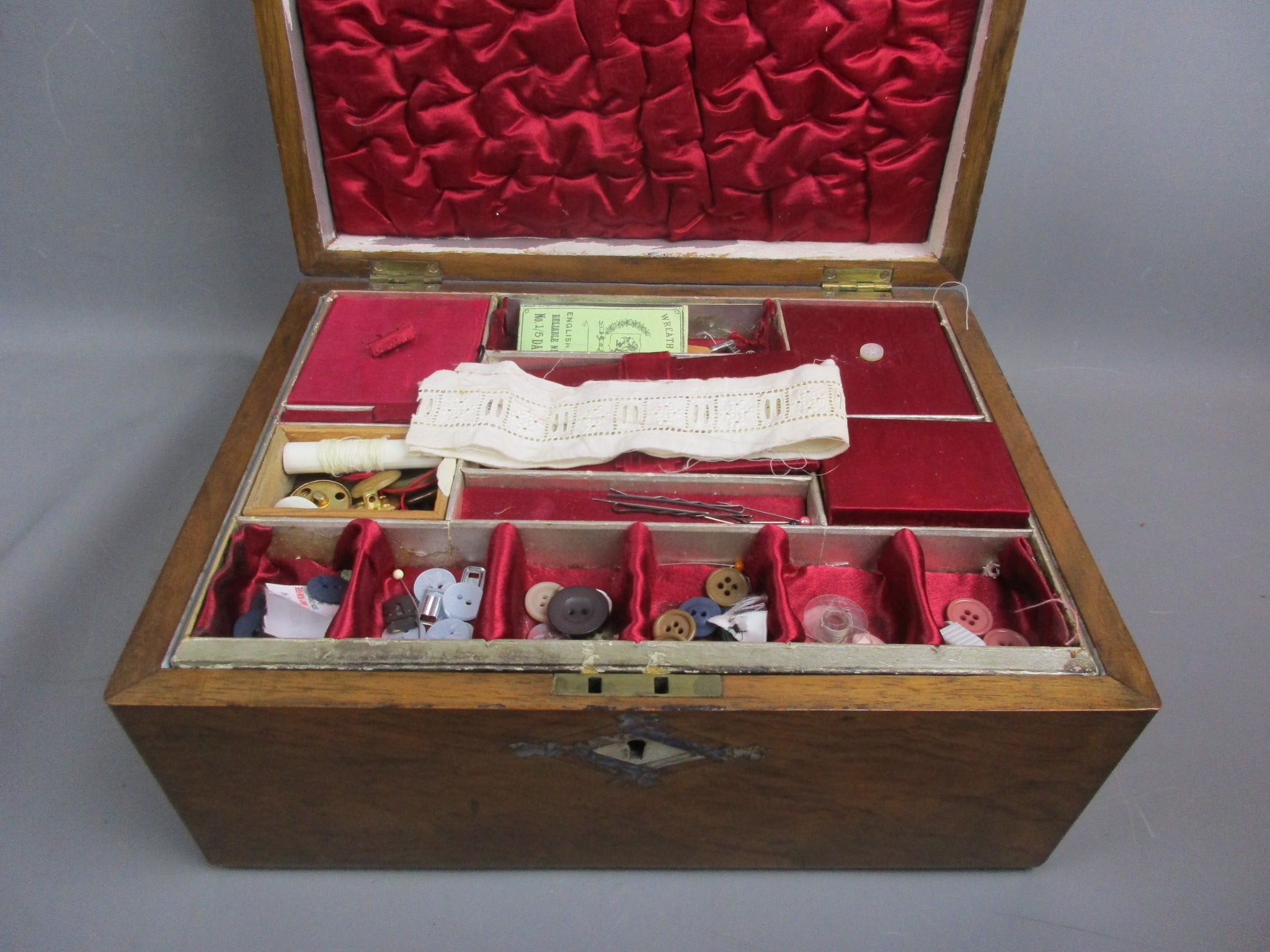 An antique rosewood sewing box with contents